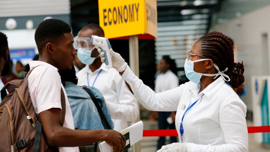 Officials in masks at the country's airport