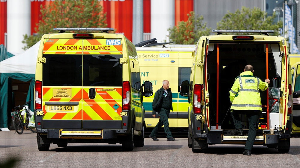 Ambulances and staff outside the NHS Nightingale Hospital at the Excel Centre in London [John Sibley/Reuters]