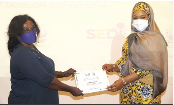 Mrs Samira Bawumia (right), the wife of the Vice-President, presenting a certificate to Ms Dora Quansah (left), one of the beneficiaries. Picture: ESTHER ADJEI