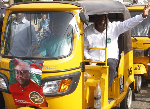 Former President John Dramani Mahama rides a tricycle popularly called 'Mahama Camboo' in the northern part of Ghana