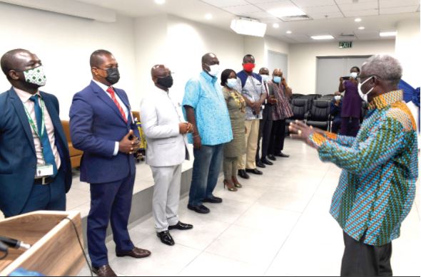 Mr Yaw Osafo-Maafo (right), the Senior Minister, interacting with members of the 10-member committee after the inauguration in Accra yesterday