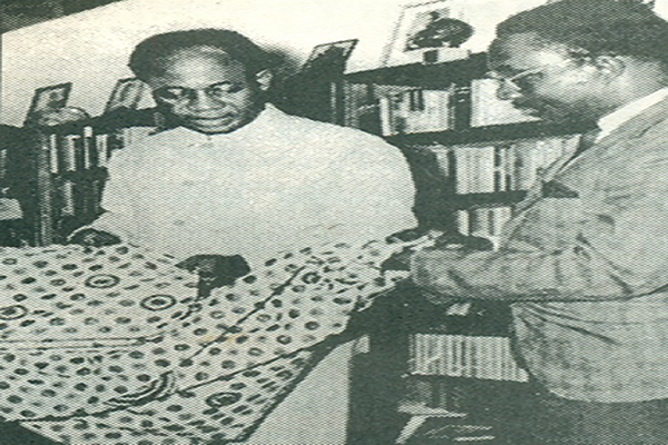 Mr Samuel .J. Anie shows his African print to former President Kwame Nkrumah