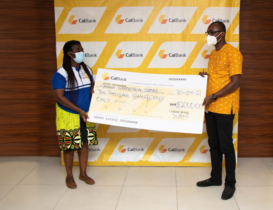 Mrs. Abena Osei-Akoto, Head of Recruitment and Training for the 2021 PHC accepting the cheque from Mr. Peter Hall, Events and Sponsorship Officer, CalBank. Looking on is Mr. Kofi Sabi, Head of Marketing, CalBank.