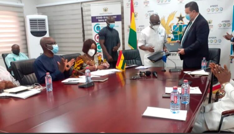 Mr Ken Ofori-Atta (2nd right), Minister of Finance, and Mr Pierre Laporte, Country Director, World Bank Group, exchanging the loan agreement after the signing yesterday. Those with them include Mrs Abena Osei-Asare (left), a Deputy Minister of Finance