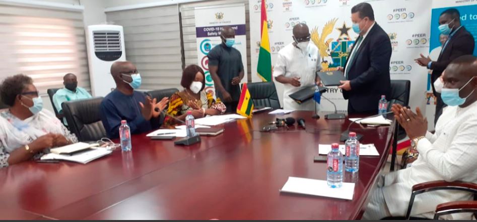 Mr Ken Ofori-Atta (2nd right), Minister of Finance, and Mr Pierre Laporte, Country Director, World Bank Group, exchanging the loan agreement after the signing yesterday. Those with them include Mrs Abena Osei-Asare (left), a Deputy Minister of Finance